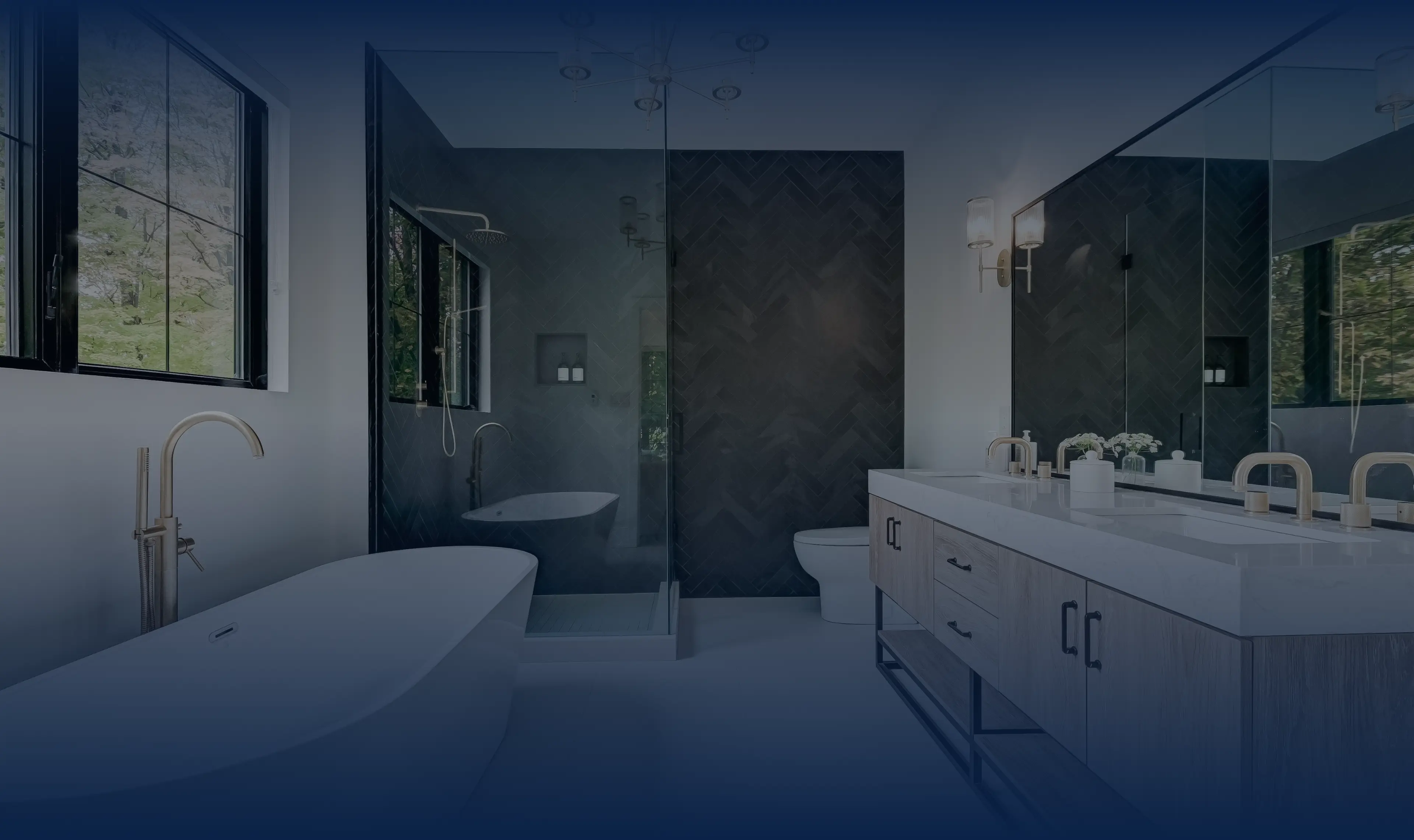 Modern bathroom with bold black herringbone tiling and brass fixtures, crafted with deliberate British refinement.